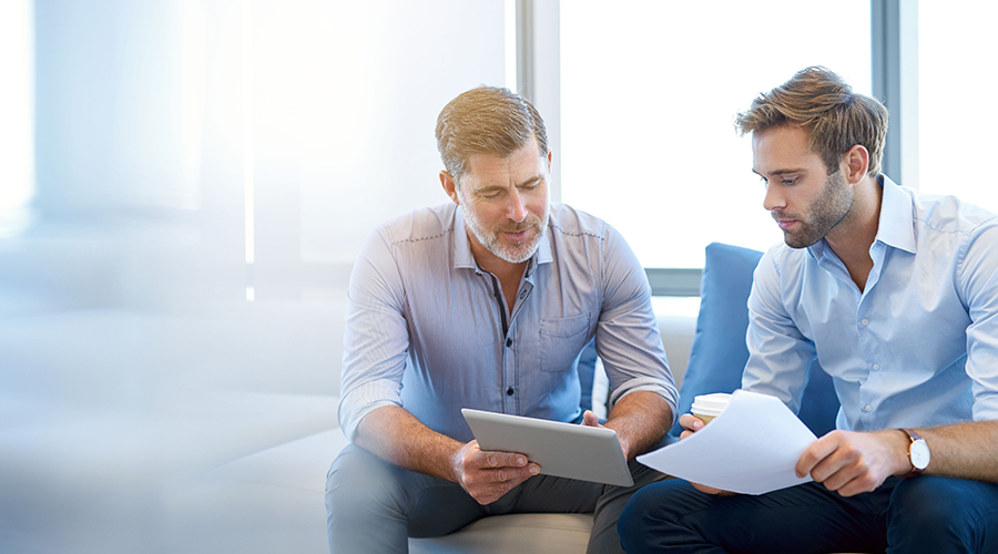 Two business men using a tablet