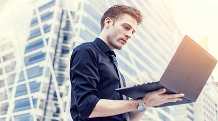 businessman use of the notebook computer outdoors                                                                                                     